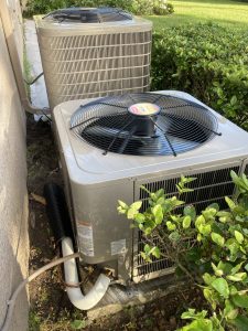 HVAC system surrounded by hedge